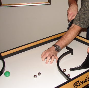 Gather balls with one hand while steering/releasing with another