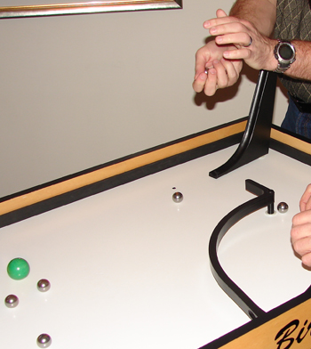 Transferring steel balls from one hand to another